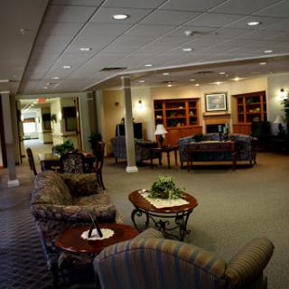 A cozy lobby area featuring comfortable seating, bookshelves, and a welcoming atmosphere.