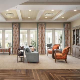 A spacious and elegantly designed living room with comfortable seating and large windows.