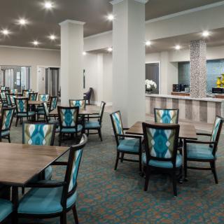 A spacious and modern dining area with neatly arranged tables and chairs.