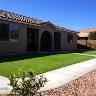 A beautiful residential property showcasing a well-maintained lawn and modern architecture.