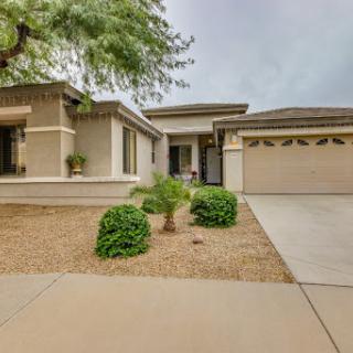 A modern suburban house with a landscaped front yard and a single-car garage.