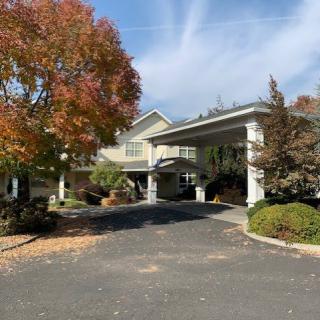 A scenic view of a building entrance surrounded by autumn foliage.