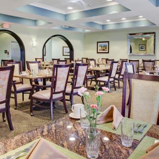 Empty restaurant dining room with neatly arranged tables and chairs.