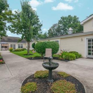 A serene courtyard with a central fountain and well-maintained landscaping.