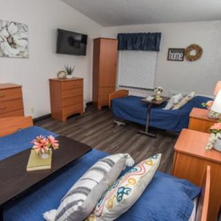 A cozy bedroom with two beds, wooden furniture, and modern decor.