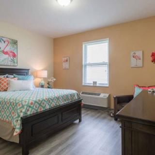 A cozy bedroom with a bed, window, and stylish decor.