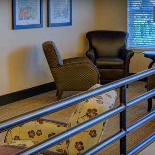 A cozy seating area with comfortable armchairs in a modern waiting room.
