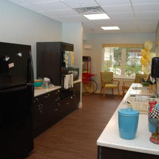 A modern kitchen with appliances and a countertop, featuring decorative elements.