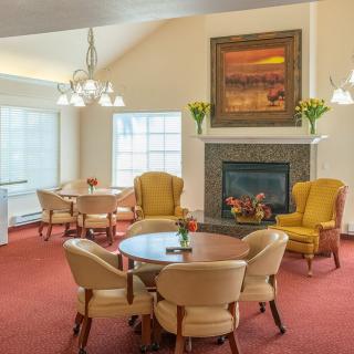 A cozy living room with elegant seating, a fireplace, and warm lighting.