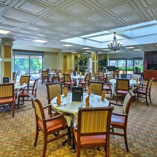 Spacious dining area with elegant table settings and natural lighting.