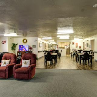 A cozy lounge and dining area featuring recliner chairs and tables for gatherings.