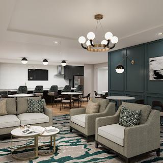 A stylish and modern living room featuring comfortable seating, elegant lighting, and vibrant decorative elements.