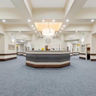 A modern reception area with a central counter and elegant lighting.