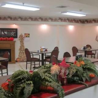 A cozy dining area decorated with festive Christmas elements, featuring tables and chairs arranged neatly.