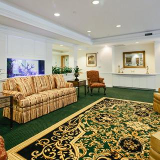 A cozy living room with ornate carpeting and comfortable seating.
