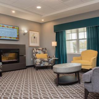 A modern living room with comfortable seating, a fireplace, and elegant decor.