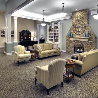 A cozy living room with comfortable seating, a fireplace, and elegant decor.