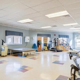 A spacious gym with exercise equipment and training facilities.