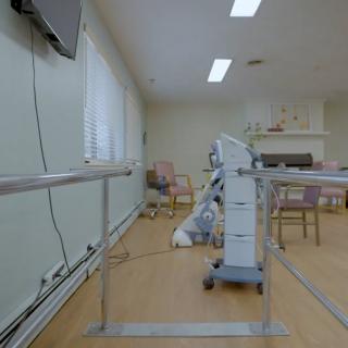 A rehabilitation room with exercise equipment for physical therapy.