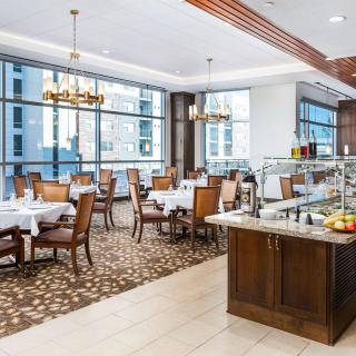 Elegant dining area with large windows and a buffet setup.