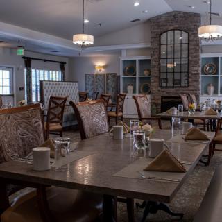 An elegant dining room with neatly set tables and comfortable chairs, ready for guests.