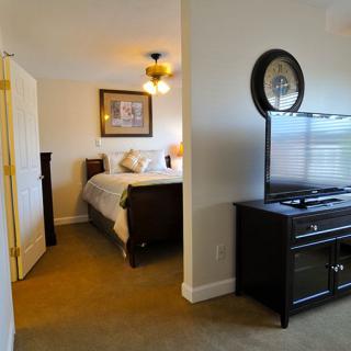 A cozy bedroom featuring a bed, television, and elegant decor.