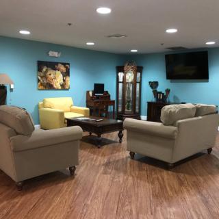 A cozy living room with sofas and a television.