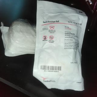 A sterile medical package alongside a white powder substance.