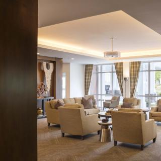 A comfortable and modern lobby seating area with plush chairs and large windows.