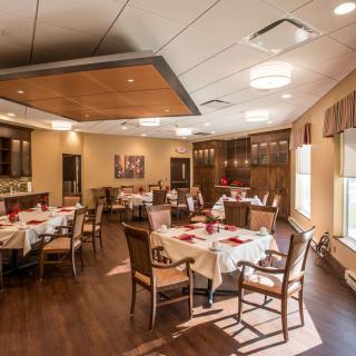 An elegant dining room with neatly arranged tables and chairs, featuring a warm and inviting interior.
