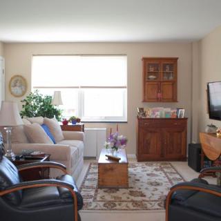A cozy living room with a sofa, TV, and decorative elements.