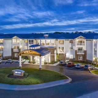A modern residential apartment complex illuminated at night.