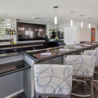 Modern bar interior with stylish seating and a well-stocked counter.
