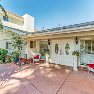A charming house with a welcoming front entrance and outdoor seating area.