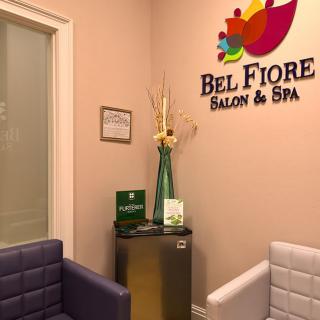 A cozy waiting area of a salon and spa with comfortable seating and elegant decor.