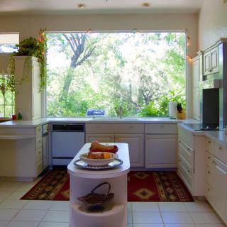 A modern kitchen with large windows providing ample natural light.