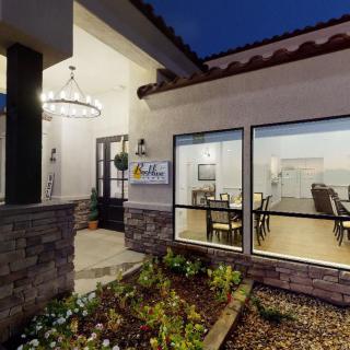 Exterior view of a house at night, showcasing modern architecture and illuminated interior.