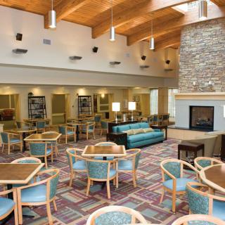 Spacious lounge area with modern furniture and a cozy fireplace.