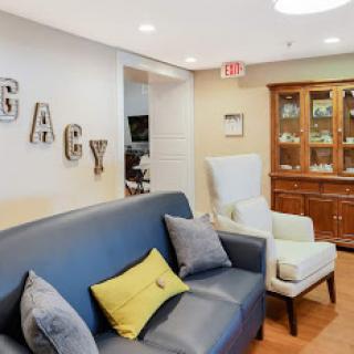 A cozy living room area featuring a comfortable sofa and stylish chairs, complemented by decorative elements.