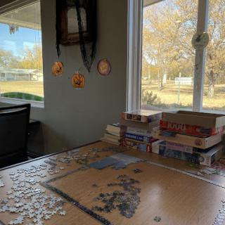 A cozy puzzle setup by the window, bringing warmth and focus to a winter afternoon.