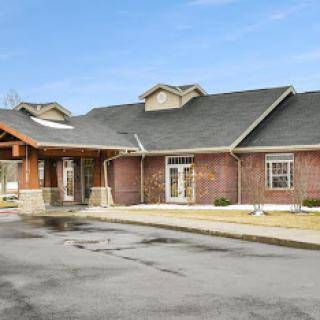 A charming brick building with a welcoming entrance and a sloped roof.