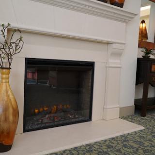 A stylish modern fireplace with a decorative vase beside it, set in a cozy interior.