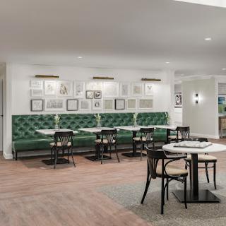 A modern dining area featuring elegant green seating and stylish decor.