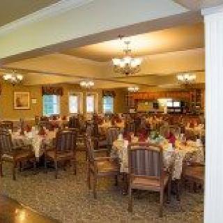 A cozy dining room with neatly arranged tables and elegant lighting.