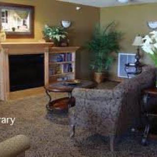A cozy living room with an elegant fireplace and comfortable seating.