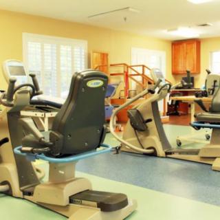 A fitness center with various exercise machines and cardio equipment.