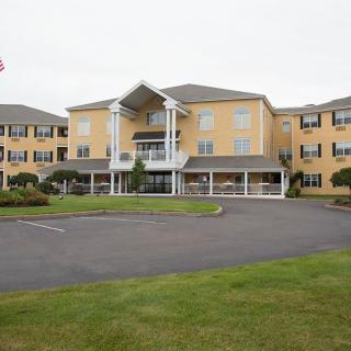 A large residential building with a well-maintained exterior and landscaped surroundings.