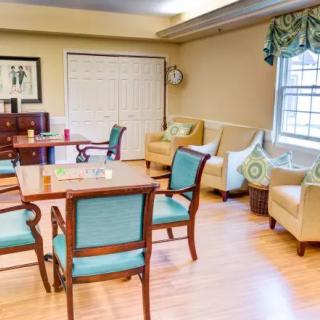 A cozy living room with comfortable seating and a table set on a wooden floor.