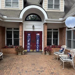 Front entrance of a house with decorative banners and seating.
