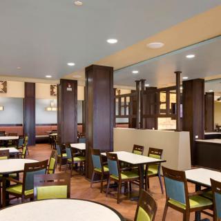 Spacious and modern dining area with neatly arranged tables and chairs.